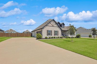 View of front facade with a garage and a front lawn | Image 2