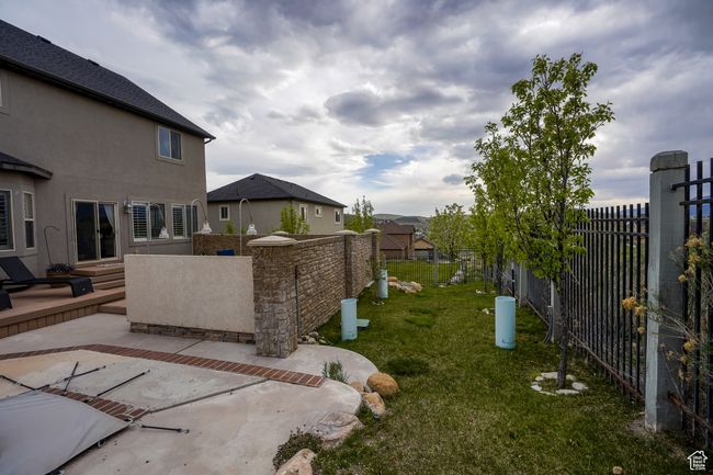 View of yard with fence and a patio area | Image 31