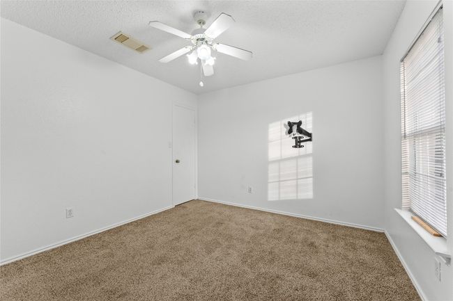 Carpeted spare room with ceiling fan, a textured ceiling, and baseboards | Image 28