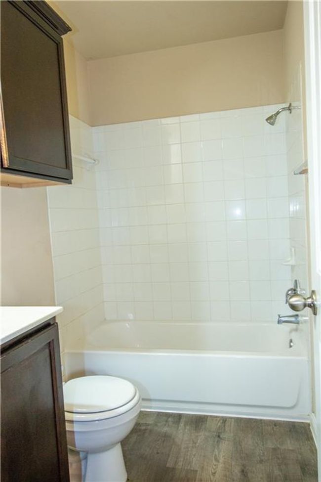Bathroom featuring vanity, bathing tub / shower combination, and wood finished floors | Image 21