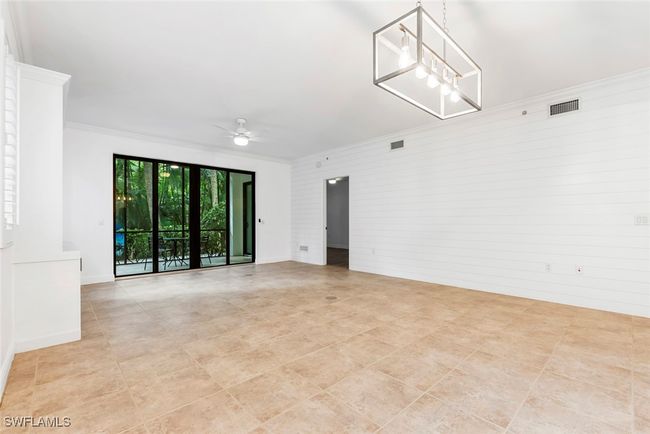 Unfurnished room featuring ornamental molding and ceiling fan with notable chandelier | Image 36