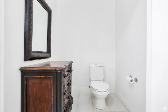 Bathroom featuring baseboards, tile patterned flooring, and toilet | Image 26