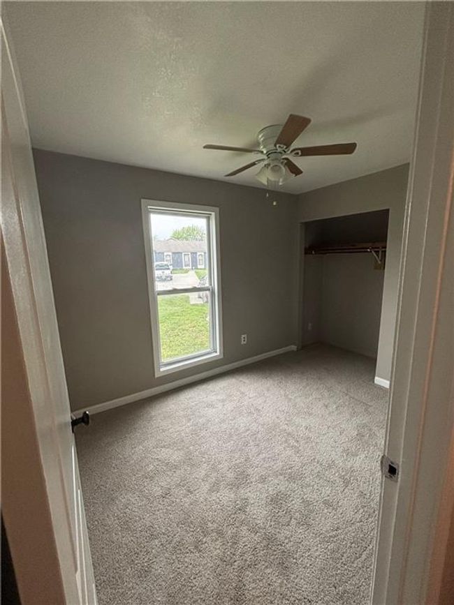 Unfurnished bedroom featuring ceiling fan, carpet, and baseboards | Image 18