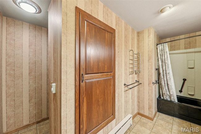 Bathroom featuring a shower with curtain, tile patterned flooring, and a textured ceiling | Image 19