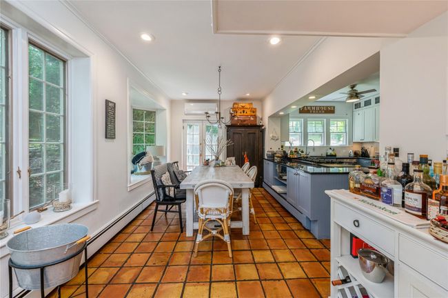 The dining area open to kitchen is a perfect place to enjoy meals. There are also French doors to a deck. | Image 9