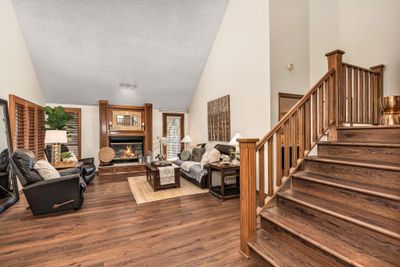 Wood floors, door to deck, vaulted ceiling, fireplace and fresh paint. | Image 3