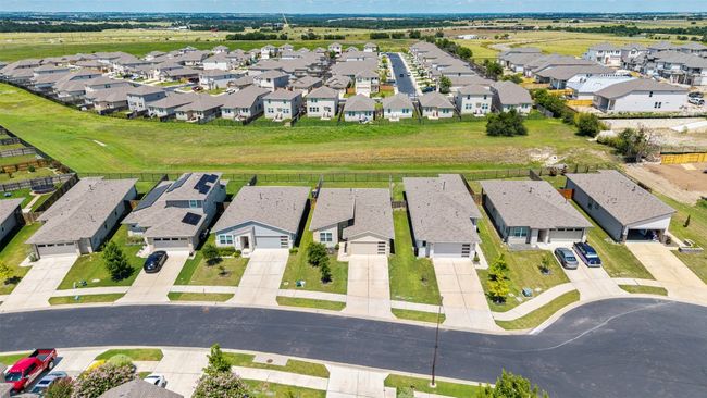 An expansive aerial shot of the neighborhood, showcasing the quiet streets and community atmosphere, while highlighting the home's place within it. | Image 28