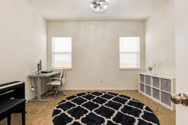 Office featuring light tile patterned floors, healthy amount of natural light, and baseboards | Image 19