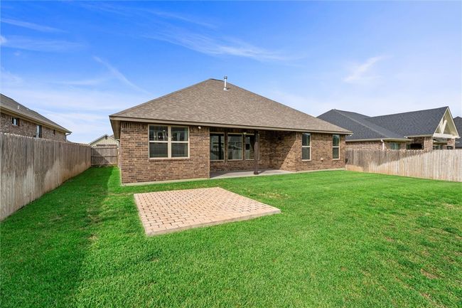 Back of property featuring brick siding, a patio, and a shingled roof | Image 33