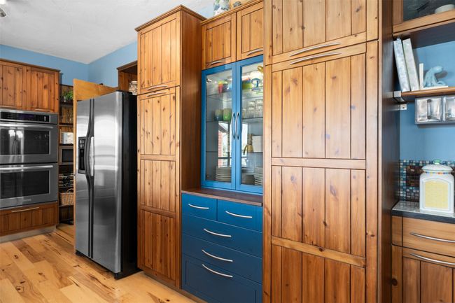 Kitchen with appliances with stainless steel finishes and light hardwood / wood-style flooring | Image 11