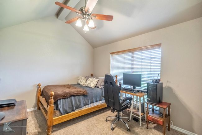 Carpeted bedroom featuring a desk, ceiling fan, and baseboards | Image 19