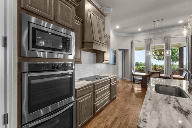 Kitchen featuring double oven and lighting under the cabinets | Image 15