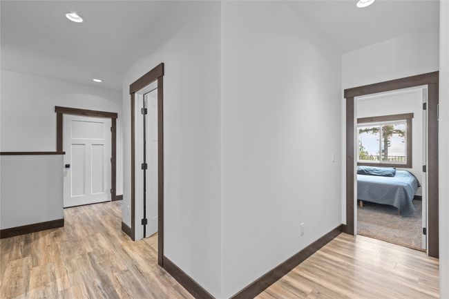 Hall with baseboards, recessed lighting, and light wood-style floors | Image 32