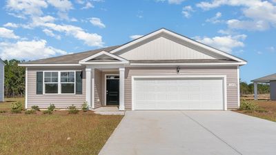 View of front of property featuring a front yard and a garage | Image 1