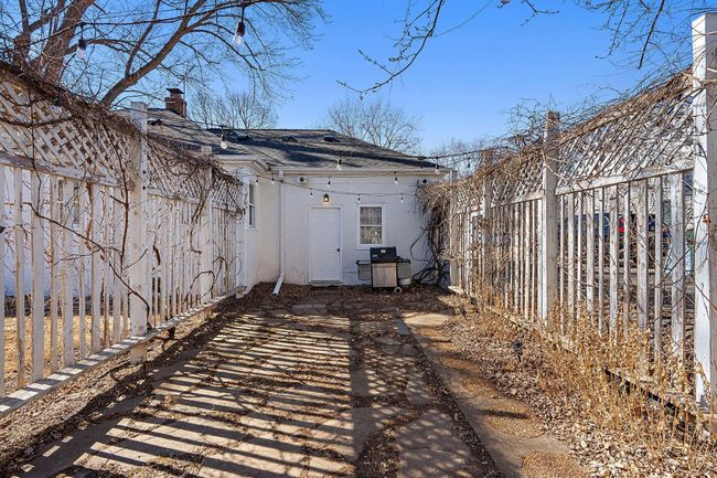 The backyard features a lovely fenced in arbor with pavers that leads to the garage door. | Image 20