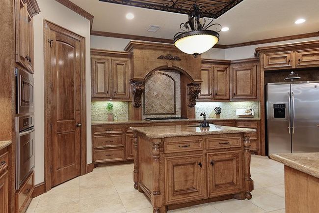 Well-appointed gourmet kitchen with large preparation island with convenient prep sink. | Image 14
