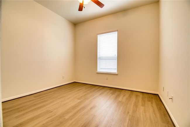 Spare room featuring wood finished floors, baseboards, and ceiling fan | Image 6