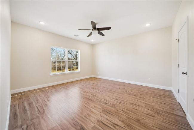 Spare room featuring light wood-type flooring and ceiling fan | Image 11