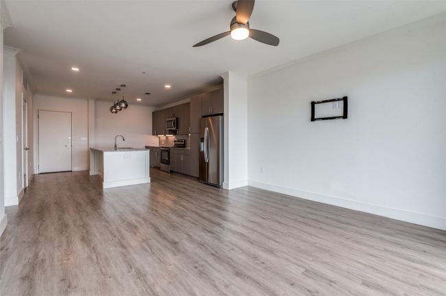 Unfurnished living room featuring recessed lighting, light wood finished floors, ceiling fan, and ornamental molding | Image 13