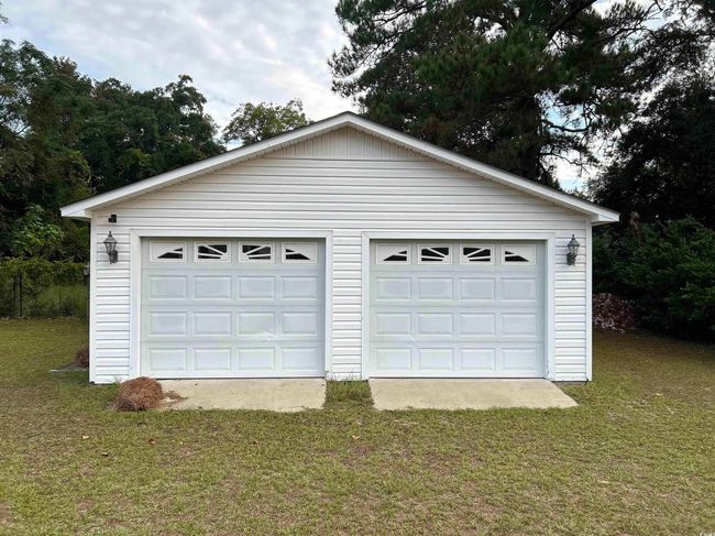 Garage featuring a lawn | Image 12