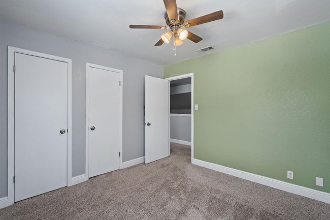 Unfurnished bedroom with carpet floors and a ceiling fan | Image 25