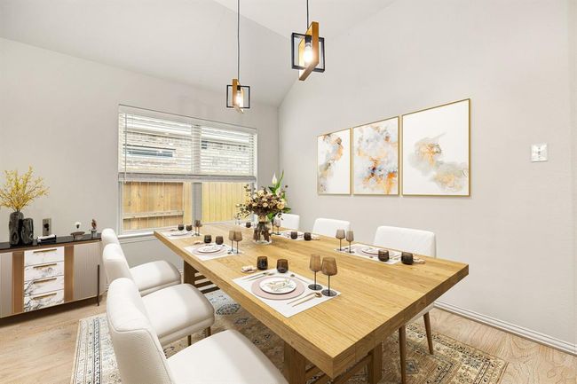 Make memories gathered around the table with your family and friends! This dining room features high ceilings, crown molding, chair rail, large windows, plush carpet and a beautiful chandelier. *Virtually Staged | Image 10