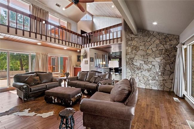Living area with hardwood / wood-style floors, a ceiling fan, beam ceiling, and high vaulted ceiling | Image 4
