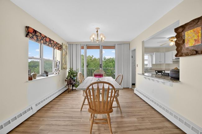 Dining space with a baseboard heating unit, a chandelier, and healthy amount of natural light | Image 13