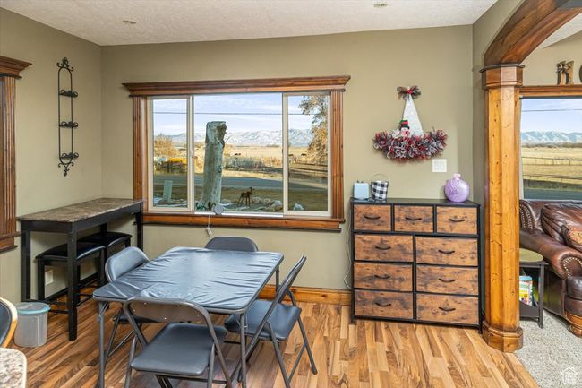 Dining space featuring a mountain view, a textured ceiling, and light wood-type flooring | Image 12