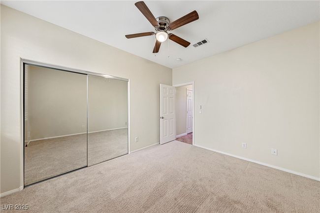 Unfurnished bedroom with carpet flooring, a closet, and ceiling fan | Image 17