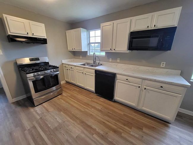 Kitchen has plenty of cabinet space, new countertops & freshly painted cabinets | Image 4