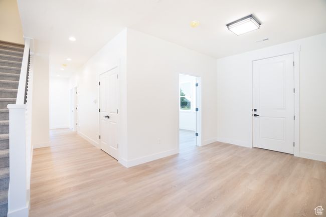 Foyer featuring stairway, light wood-style flooring, and recessed lighting | Image 10