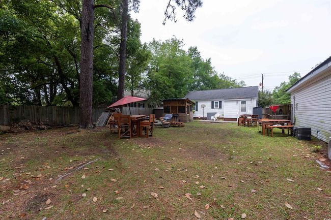 View of yard featuring fence and an outbuilding | Image 13