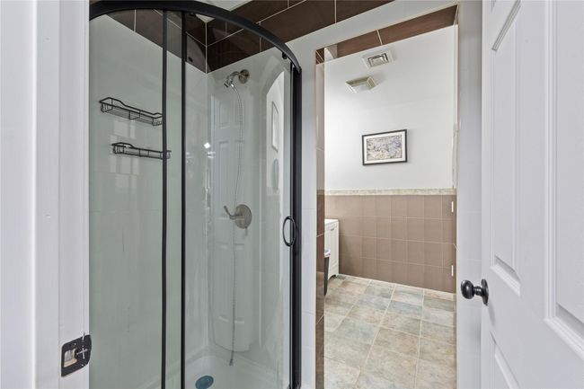 Bathroom with tile walls and walk in shower | Image 42