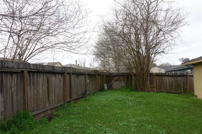 Charming backyard with lush greenery, mature trees, and privacy fencing—perfect for relaxation and outdoor activities. | Image 29