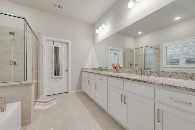 Full bathroom with tile patterned floors, double vanity, a sink, visible vents, and a stall shower | Image 17