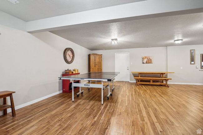 Playroom with baseboards, a textured ceiling, and light wood finished floors | Image 43