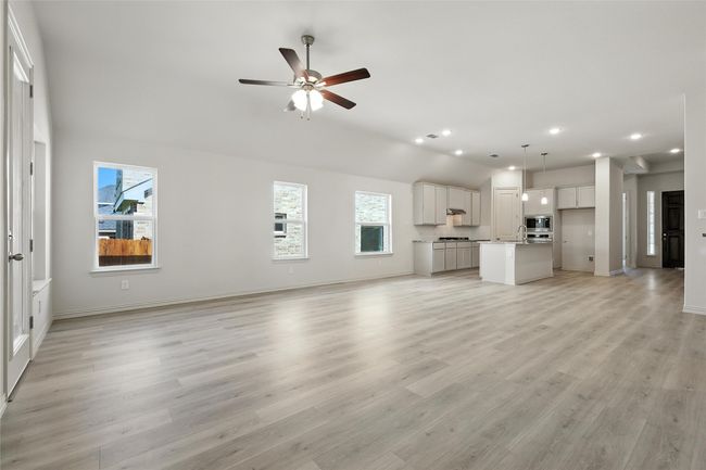 Unfurnished living room with recessed lighting, a ceiling fan, light wood-style flooring, and vaulted ceiling | Image 14