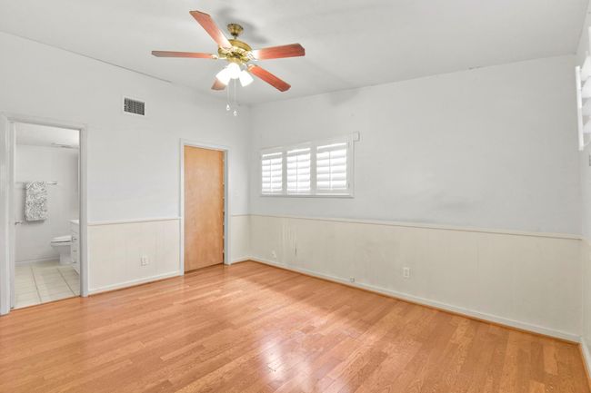 Spacious primary bedroom featuring a generous walk-in closet with custom built-in shelving. | Image 21