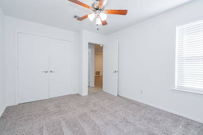 Unfurnished bedroom featuring visible vents, baseboards, a closet, and light carpet | Image 33