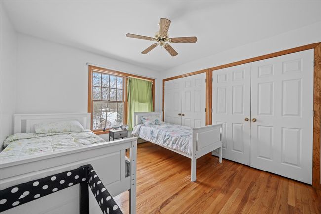 Bedroom featuring ceiling fan, light wood-style floors, and two closets | Image 36