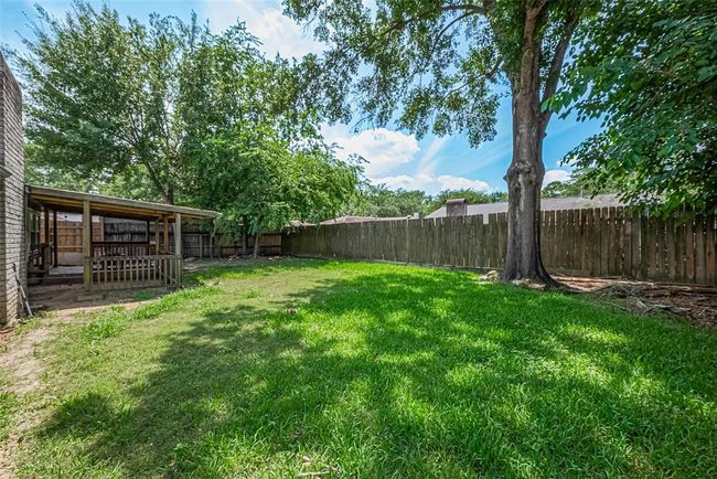 This backyard is large enough for both a private garden area or a playground set! | Image 22