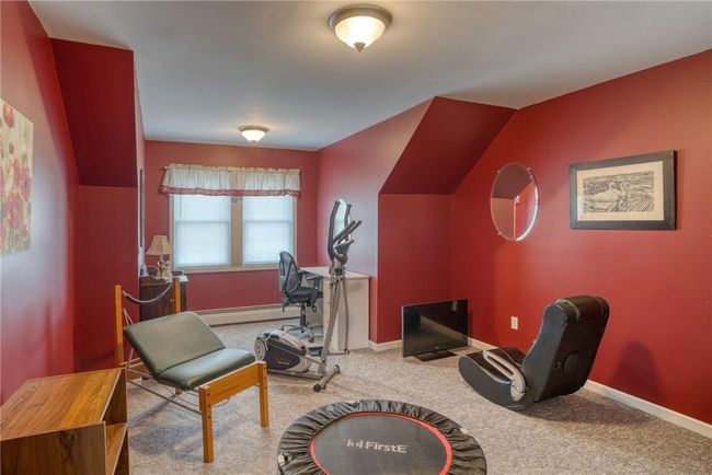 Sitting room with a baseboard radiator and carpet flooring | Image 25