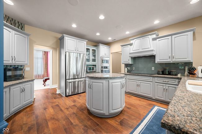 kitchen with black appliances, dark wood-type flooring, decorative backsplash, and recessed lighting | Image 33
