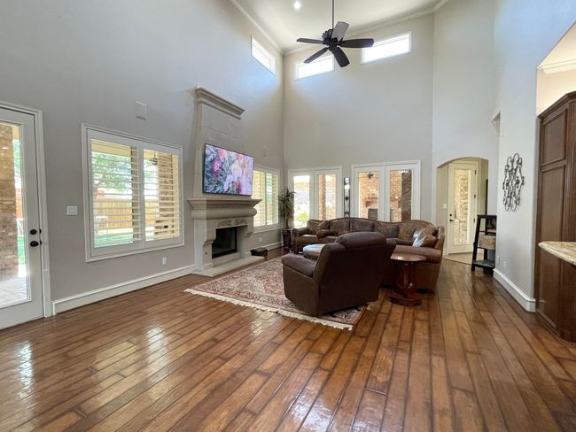 Family room with fireplace and plenty of windows | Image 13