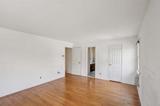 Unfurnished bedroom featuring ensuite bath and light wood finished floors | Image 24