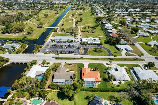 Aerial view of property's location featuring a large body of water and nearby suburban area | Image 4