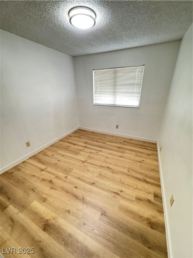 Unfurnished room with wood finished floors and a textured ceiling | Image 37