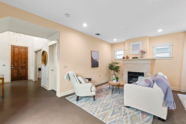 Open floorplan for the living area with gas fireplace. | Image 11