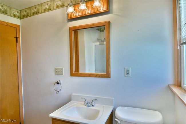 Bathroom featuring toilet and vanity | Image 31
